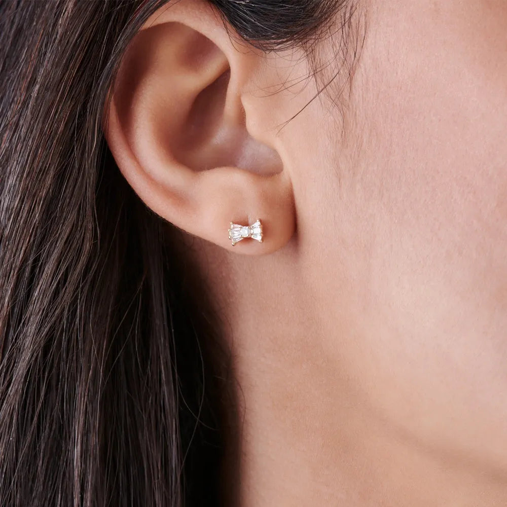 14k Gold Diamond Baguette and Round Cut Bow Stud Earrings 0.25 ctw