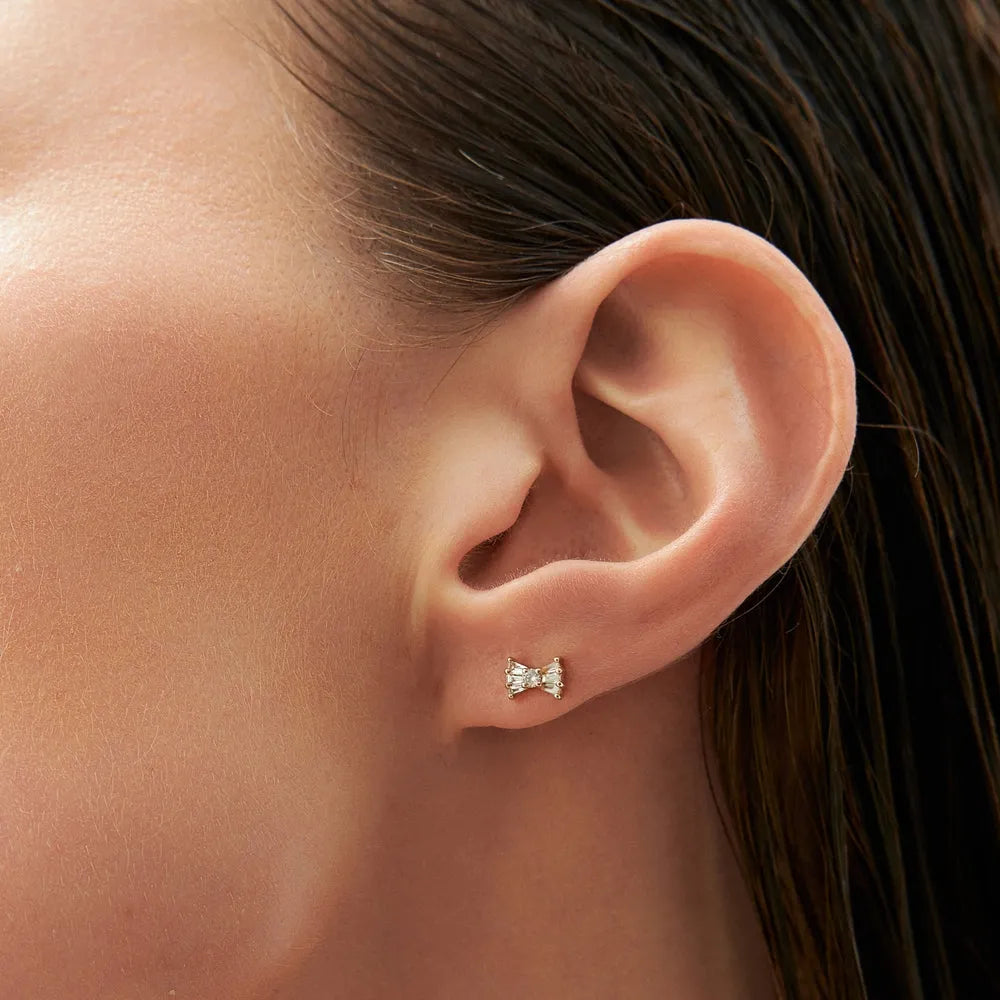 14k Gold Diamond Baguette and Round Cut Bow Stud Earrings 0.25 ctw
